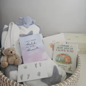 A basket filled with a baby blanket. cuddly toys, a card, Guess How Much I Love You book and Ronnie's hand and footprints